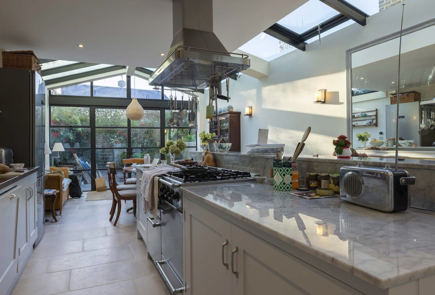 Open-plan kitchen renovation with a glazed rear extension, roof lantern and marble worktops